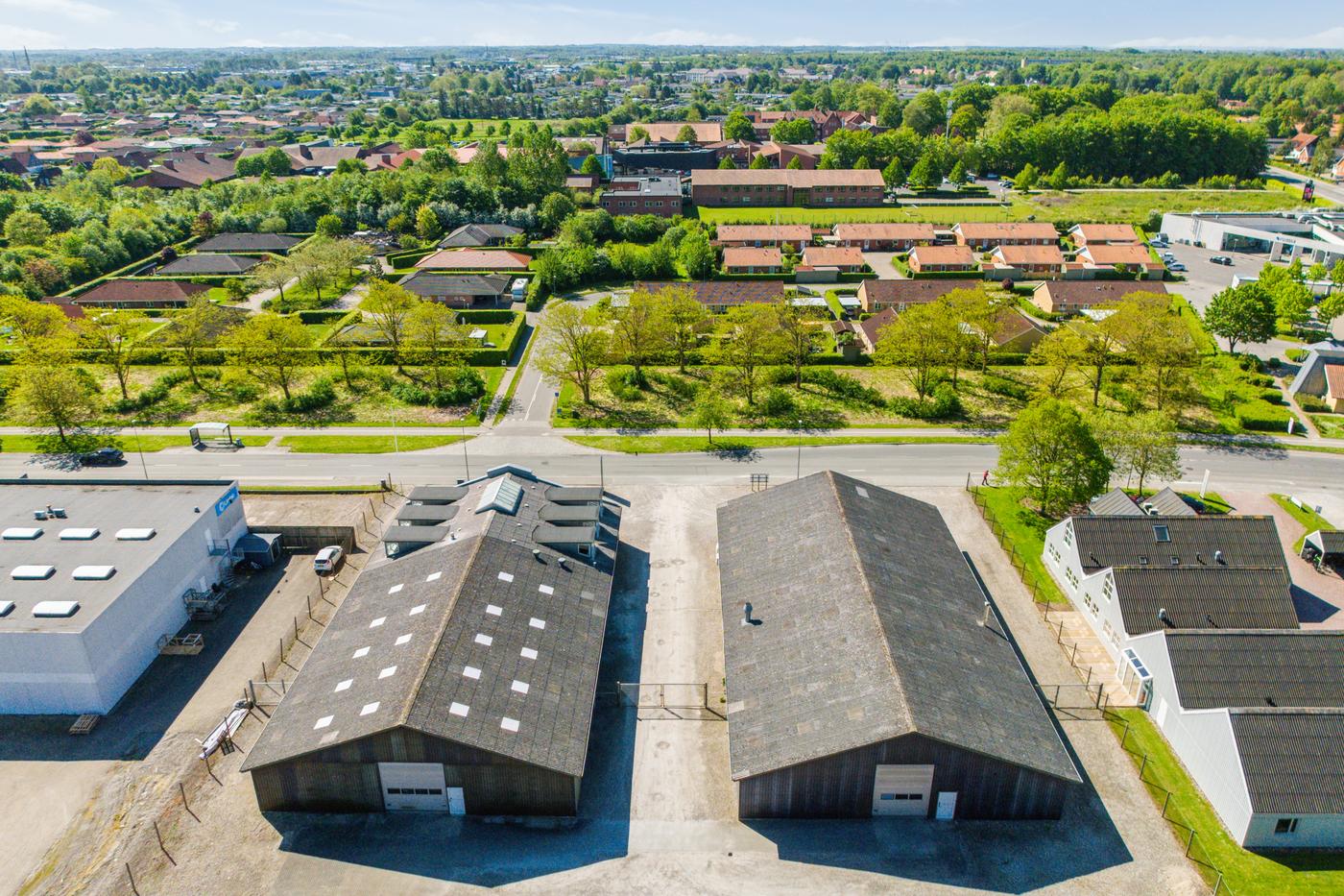 RoboHouse at Landbrugsvej 6 seen from the air, with the two halls in the foreground and Odense S beyond